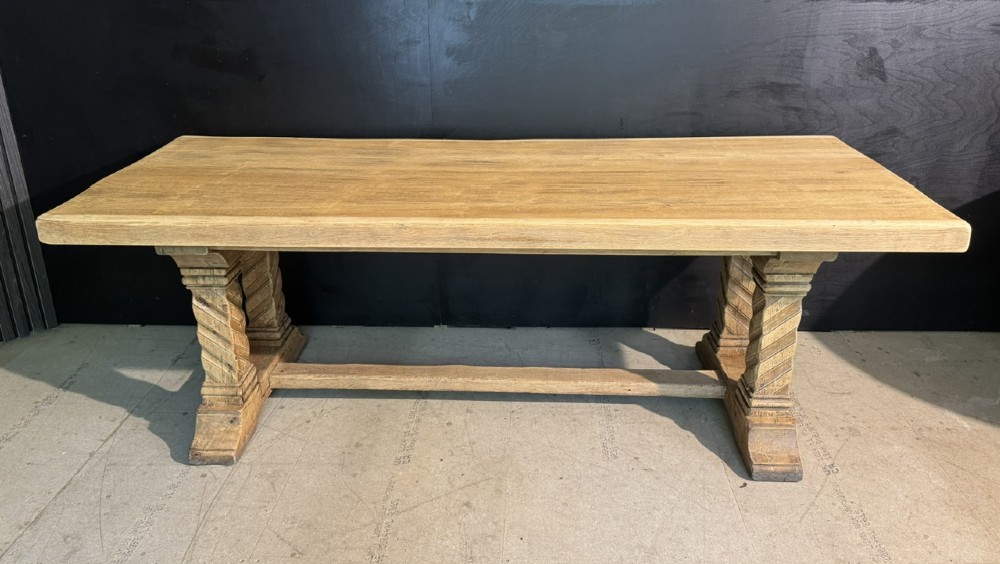 A large French rustic light oak dining table featuring a thick rectangular top supported by carved spiral trestle legs and a central stretcher. View IV