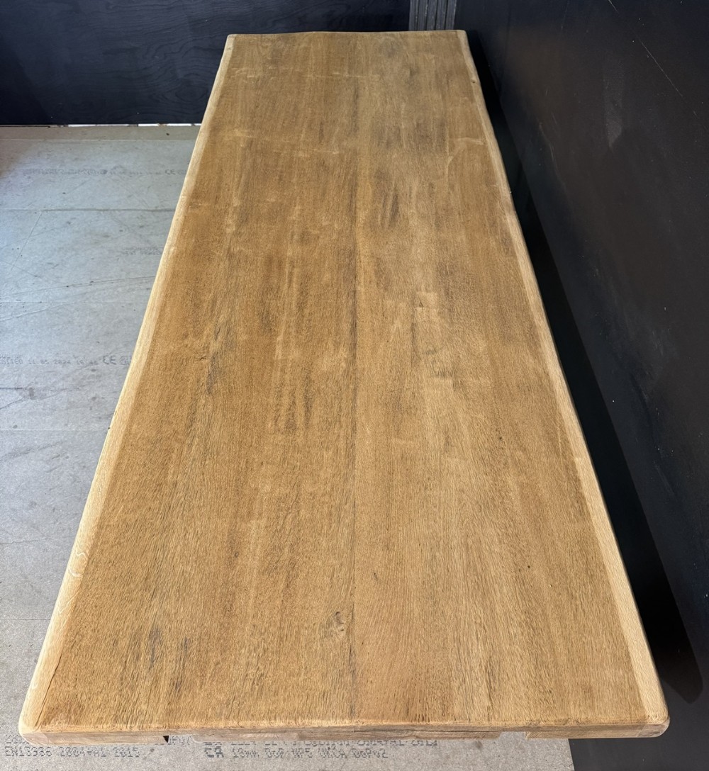 A large French rustic light oak dining table featuring a thick rectangular top supported by carved spiral trestle legs and a central stretcher. View VI