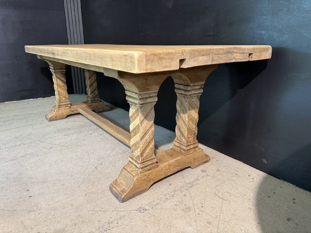 A large French rustic light oak dining table featuring a thick rectangular top supported by carved spiral trestle legs and a central stretcher. View VIII