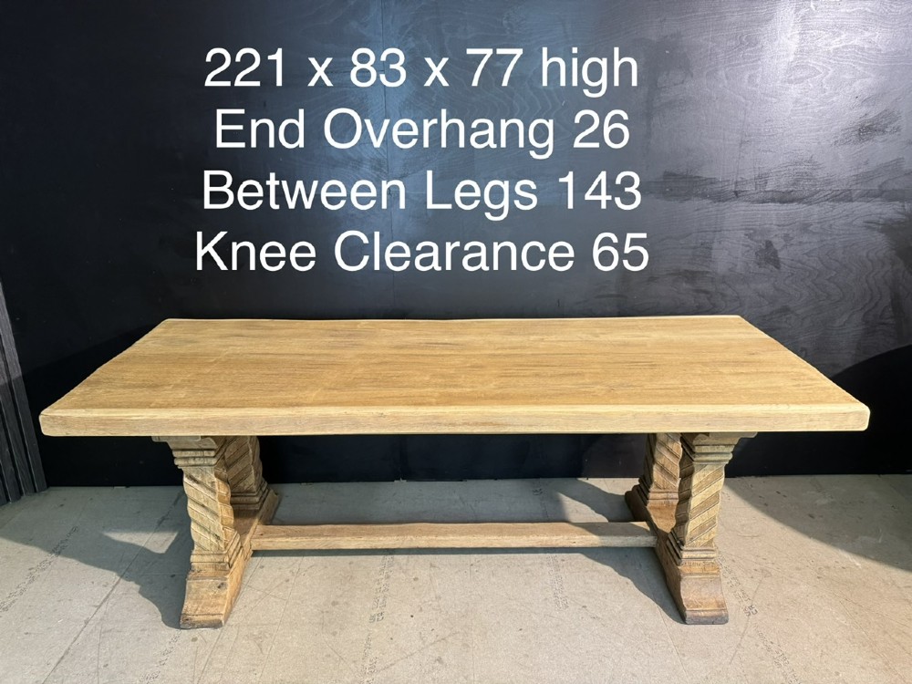 A large French rustic light oak dining table featuring a thick rectangular top supported by carved spiral trestle legs and a central stretcher. View XIV