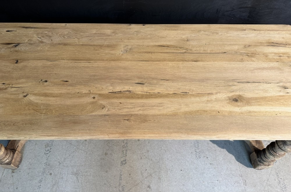 A long light oak French farmhouse table featuring a thick plank top, two frieze drawers, thick turned legs, and an H-stretcher base. View XII