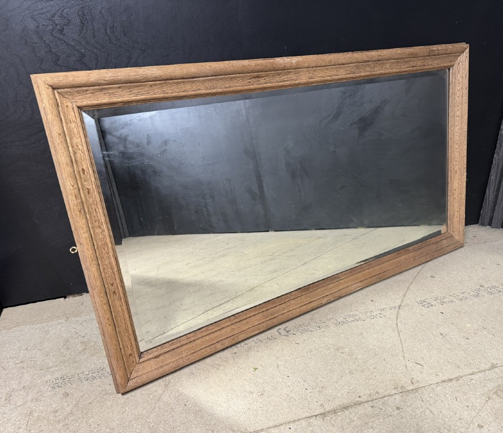 A large rectangular 19th-century French wall mirror with a moulded natural oak frame and a bevelled glass plate. View II