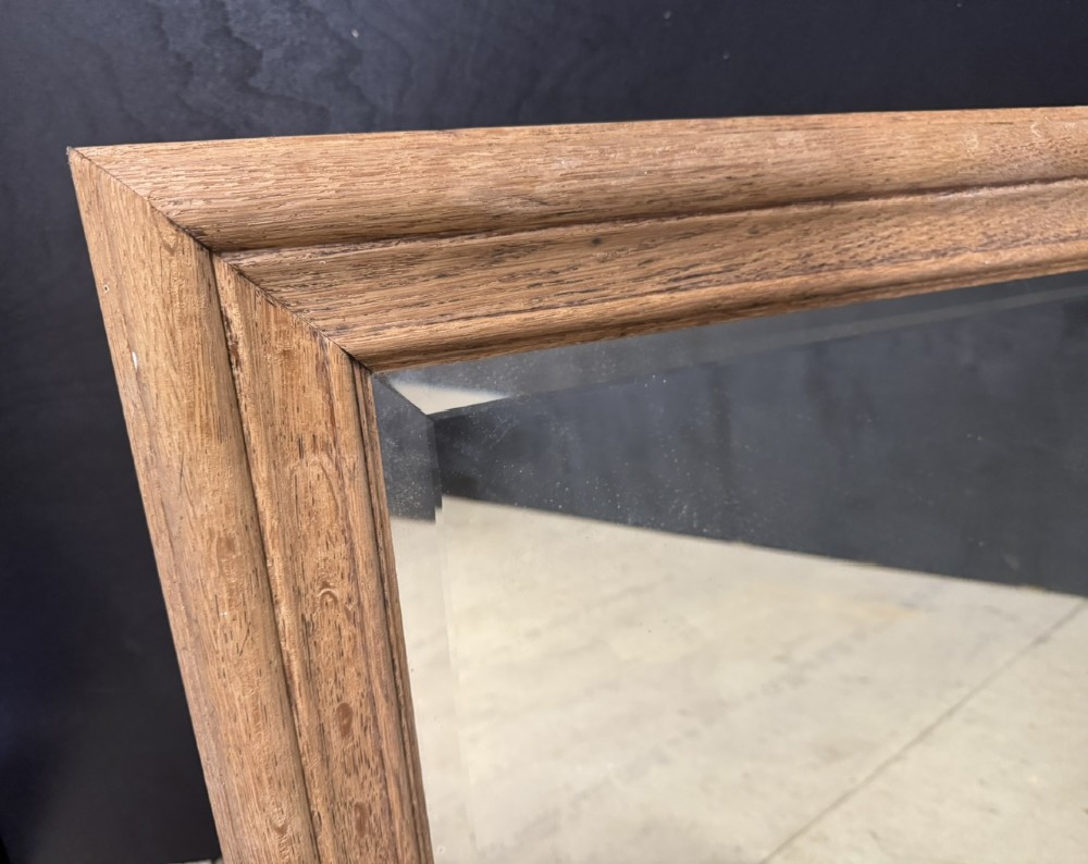 A large rectangular 19th-century French wall mirror with a moulded natural oak frame and a bevelled glass plate. View X