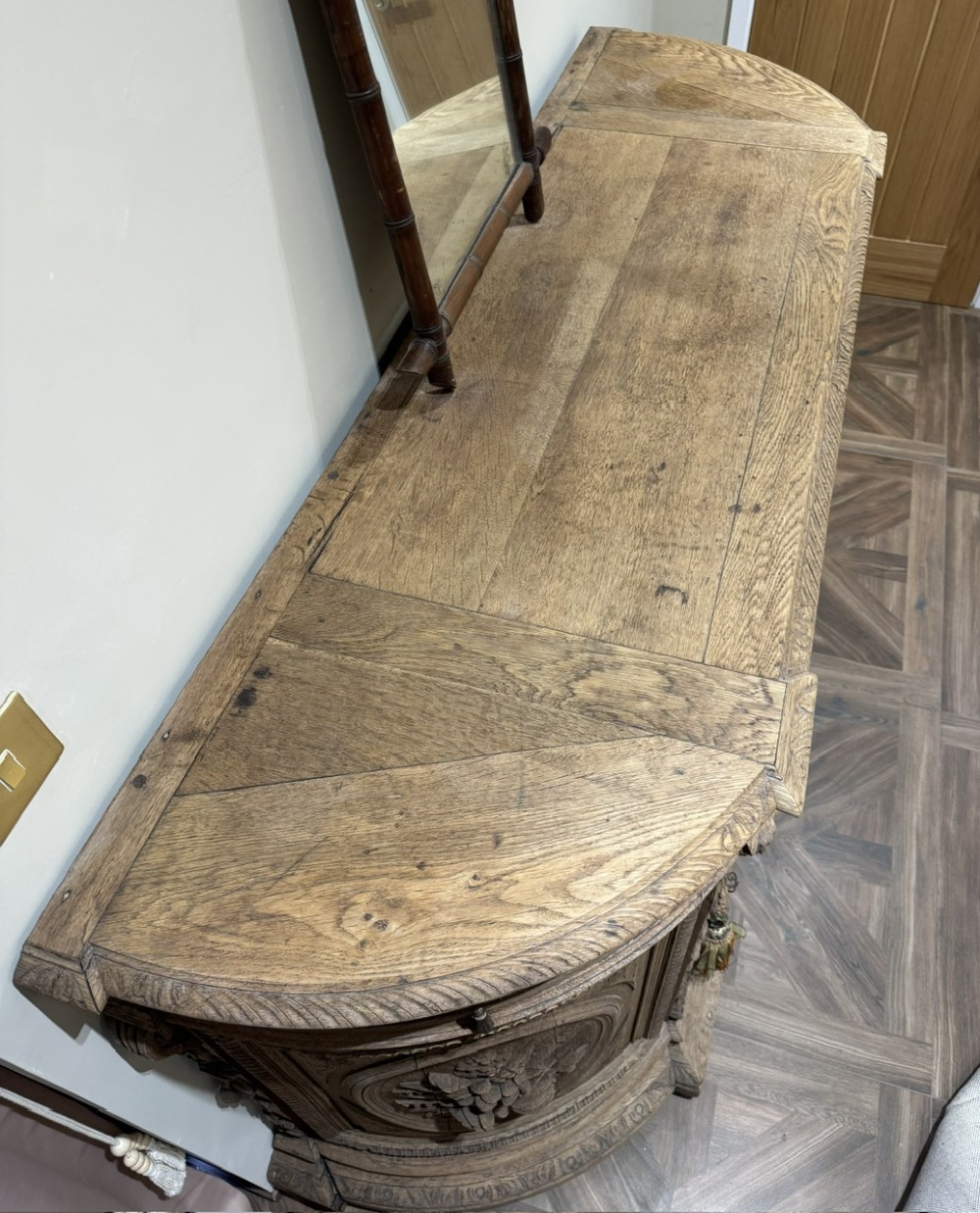 A light oak sideboard with detailed relief carvings of deer in a forest setting on the central panel, flanked by foliage motifs. View X