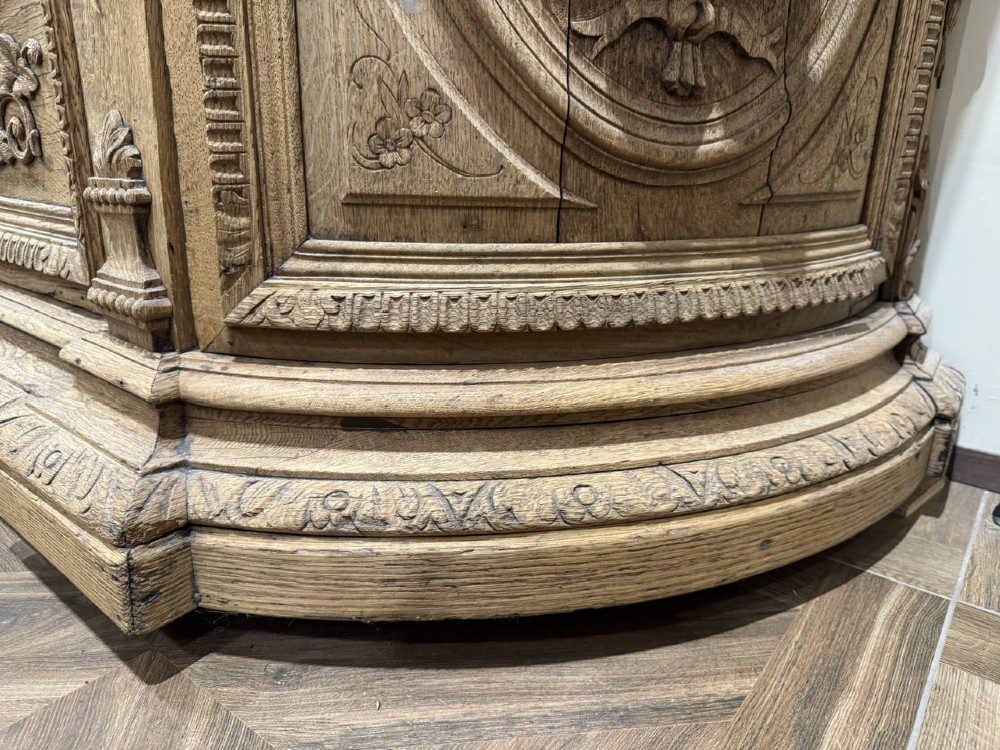 A light oak sideboard with detailed relief carvings of deer in a forest setting on the central panel, flanked by foliage motifs. View XIV