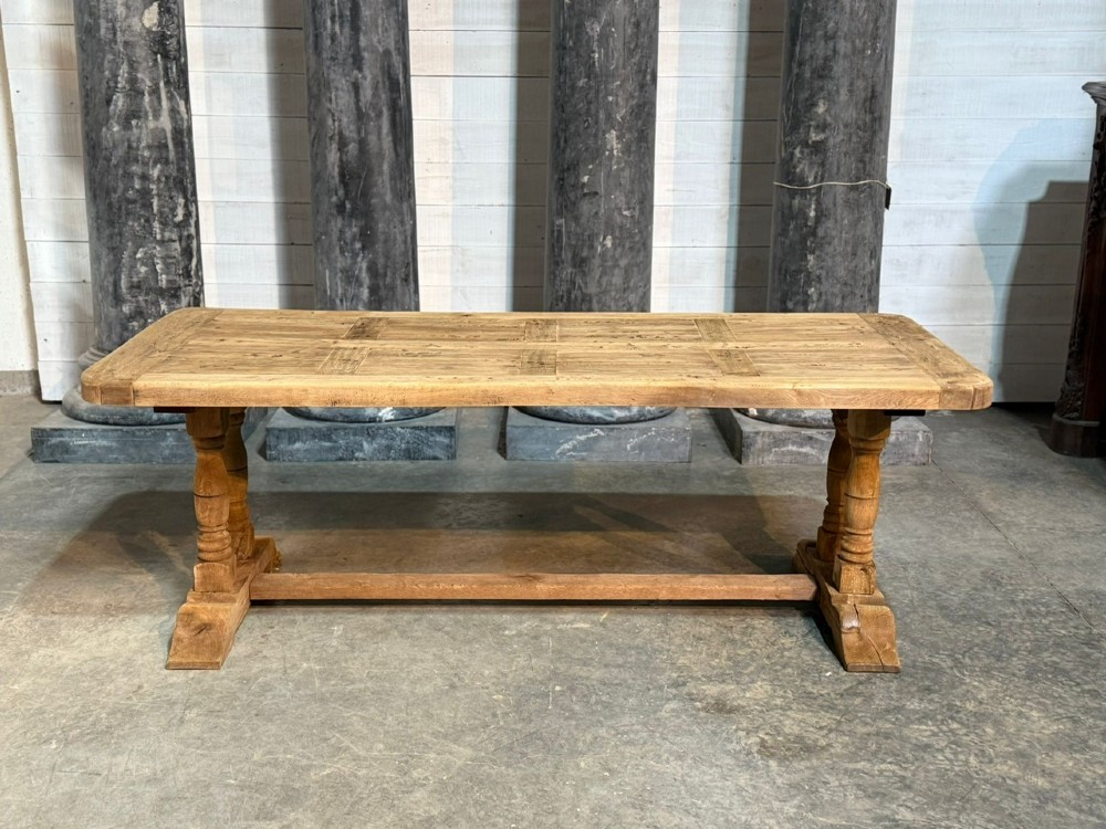 A rectangular French oak dining table featuring a parquetry top, twin turned pedestal legs, and a low central stretcher base. View III