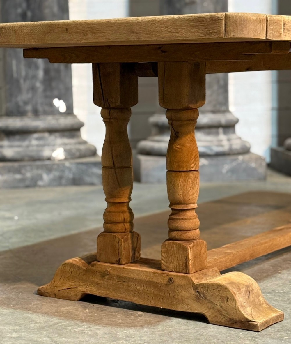 A rectangular French oak dining table featuring a parquetry top, twin turned pedestal legs, and a low central stretcher base. View IX