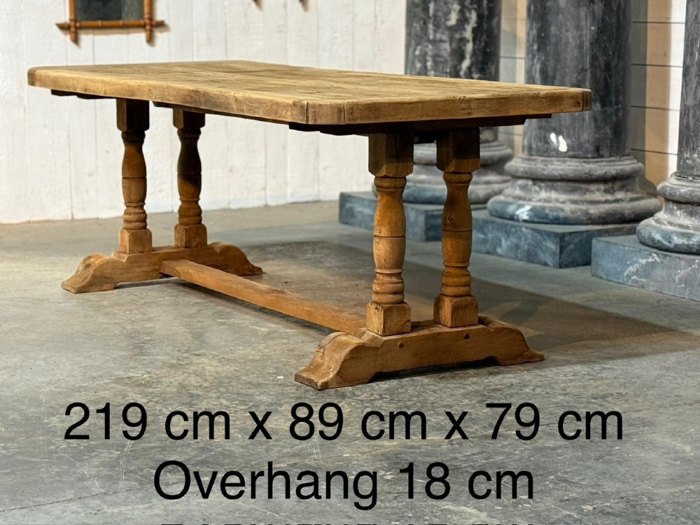 A rectangular French oak dining table featuring a parquetry top, twin turned pedestal legs, and a low central stretcher base. View X