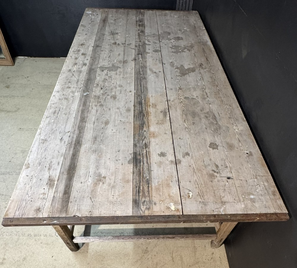 A large rustic wooden French prep table featuring a weathered scrubbed timber top, corner support brackets, and low perimeter stretchers. View V