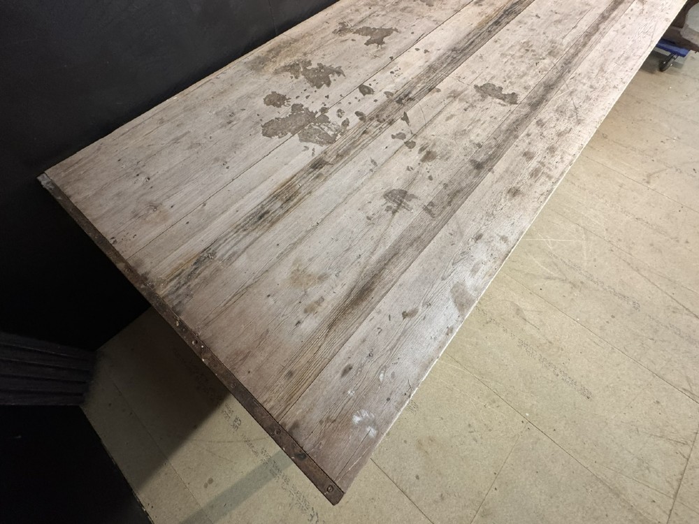 A large rustic wooden French prep table featuring a weathered scrubbed timber top, corner support brackets, and low perimeter stretchers. View VI