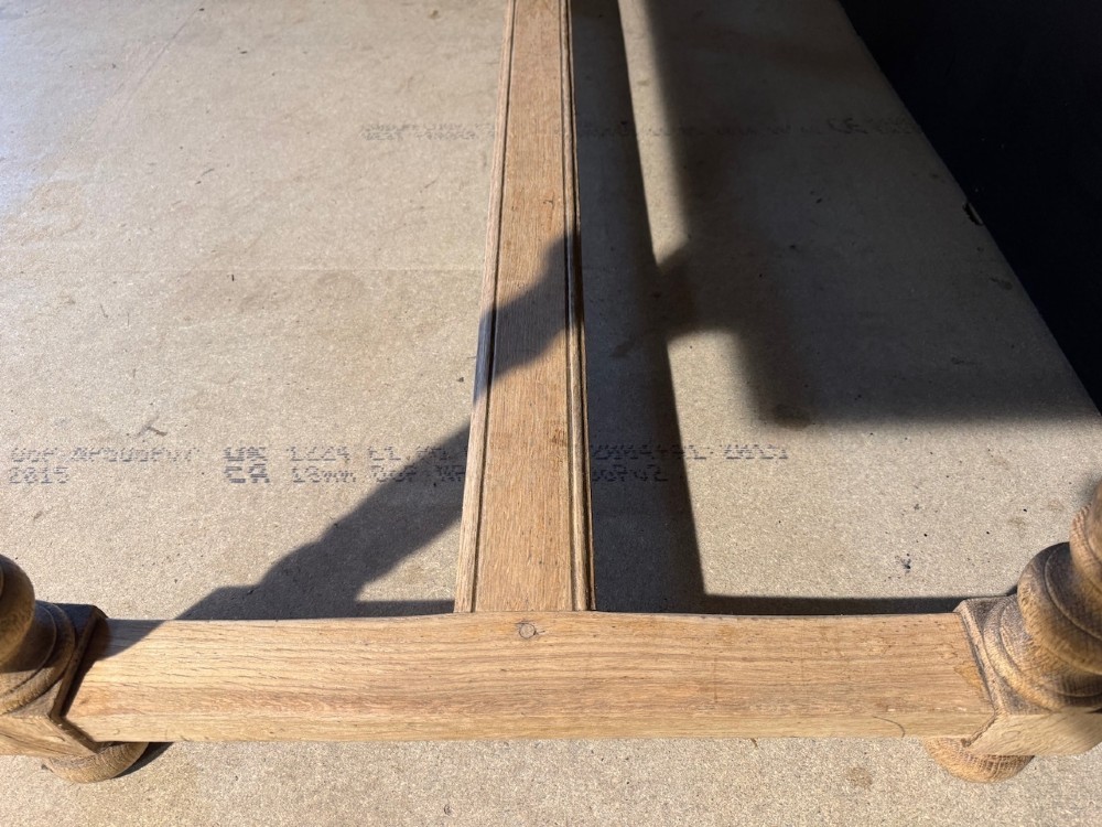 A light natural oak farmhouse dining table featuring turned legs, an H-stretcher base, and a planked top with cleated breadboard ends. View VIII