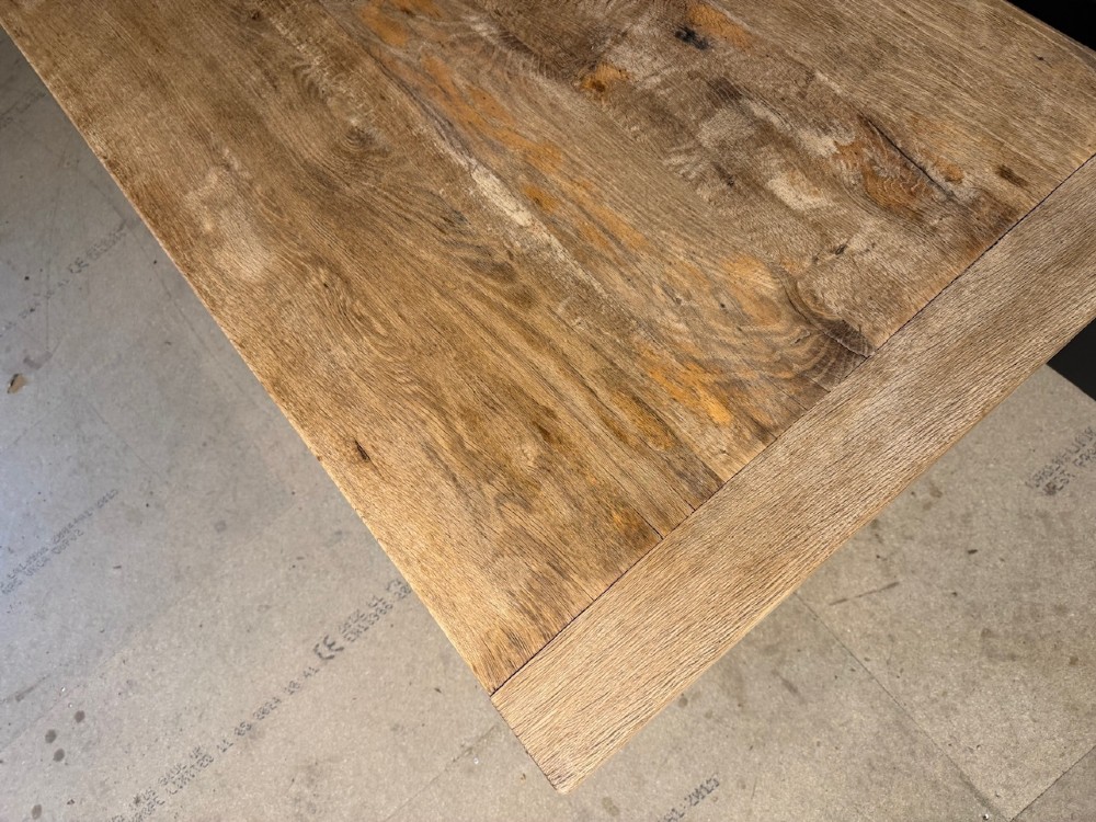 A light natural oak farmhouse dining table featuring turned legs, an H-stretcher base, and a planked top with cleated breadboard ends. View XII