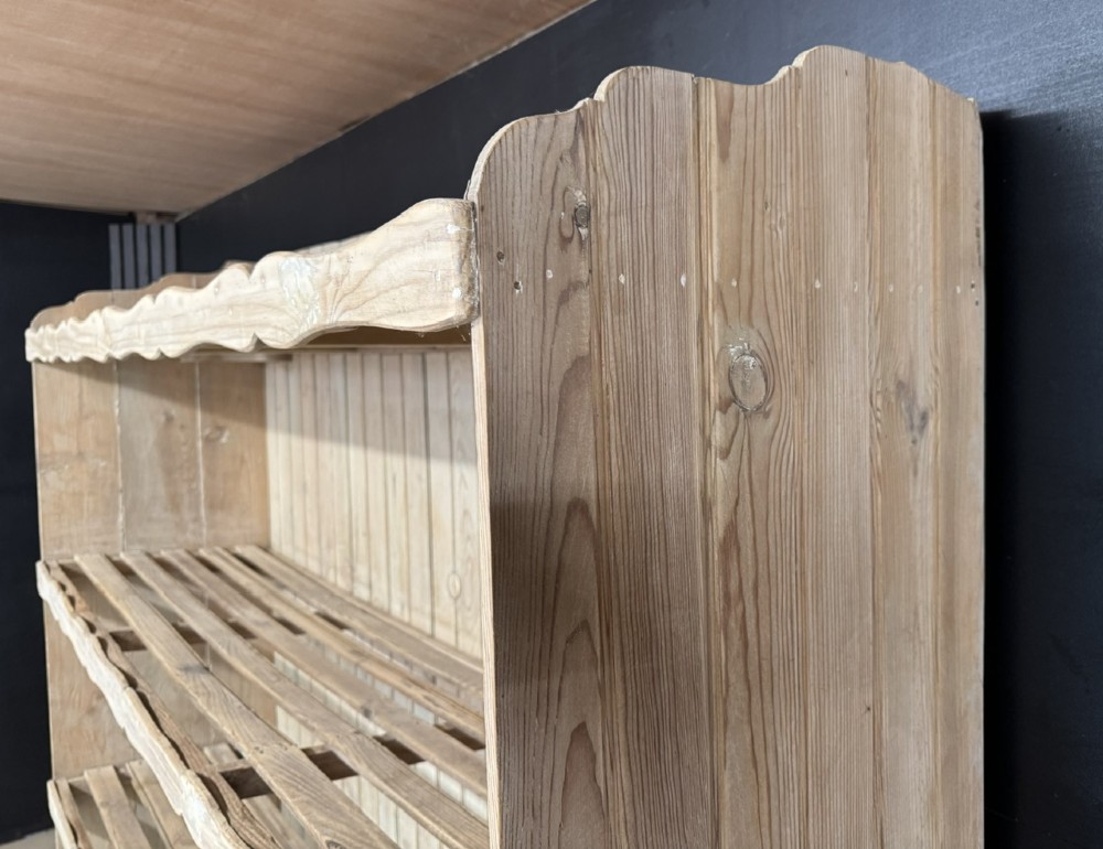 A large 19th-century French pine bakers rack featuring four slatted timber shelves and scalloped front aprons. View IX