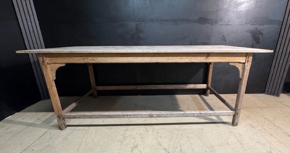 A large rustic wooden French prep table featuring a weathered scrubbed timber top, corner support brackets, and low perimeter stretchers. View XIII