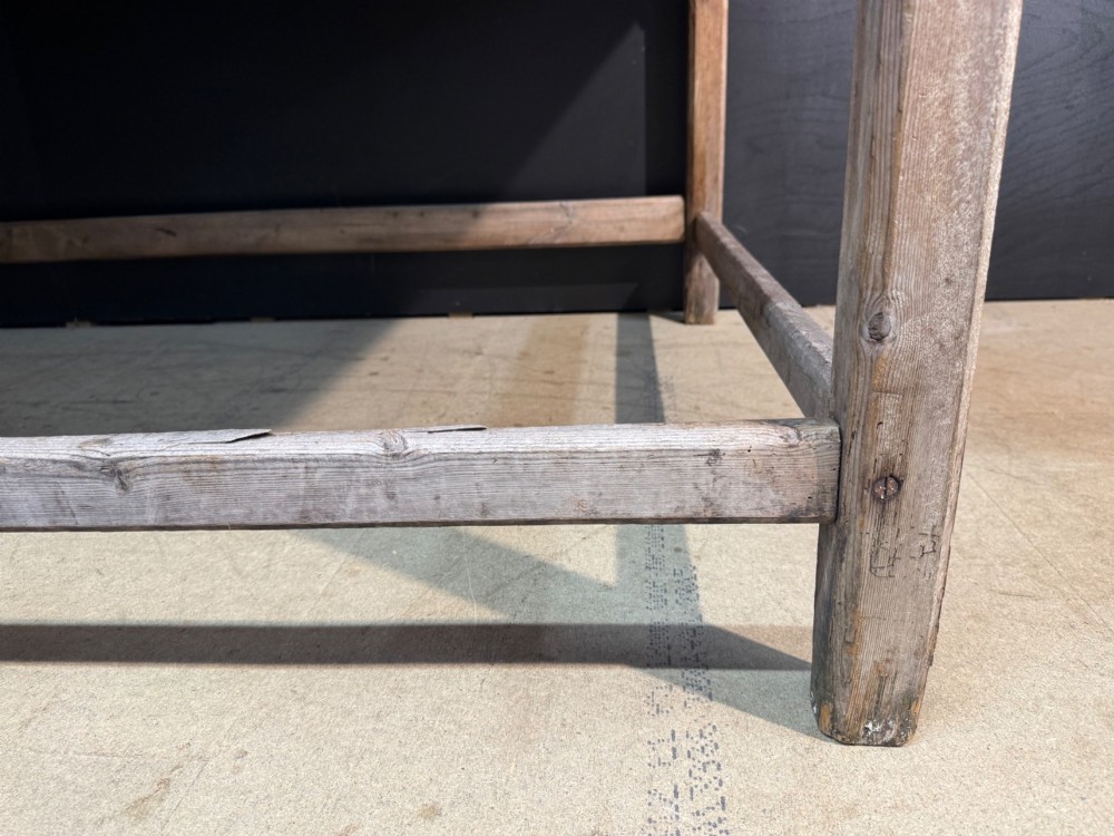 A large rustic wooden French prep table featuring a weathered scrubbed timber top, corner support brackets, and low perimeter stretchers. View XIV