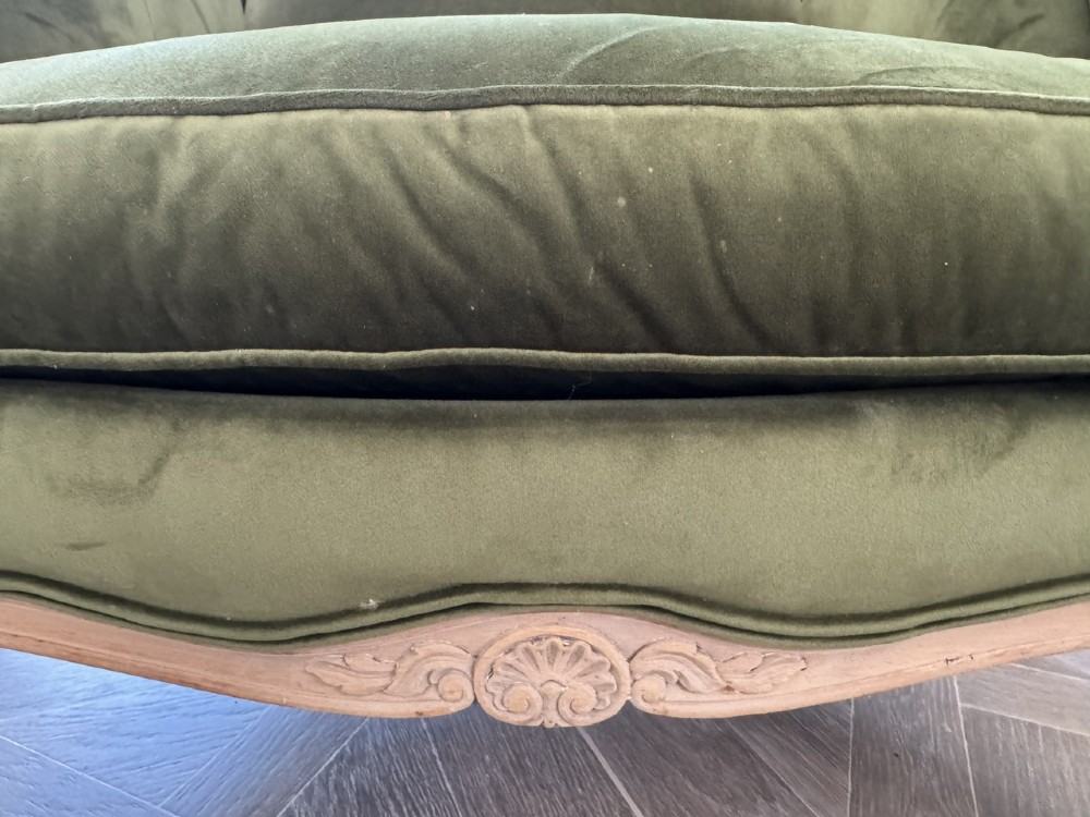 A pair of French wingback armchairs upholstered in olive green velvet with carved timber frames and cabriole legs. View IV