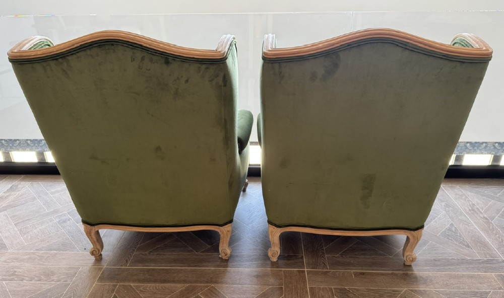 A pair of French wingback armchairs upholstered in olive green velvet with carved timber frames and cabriole legs. View VII