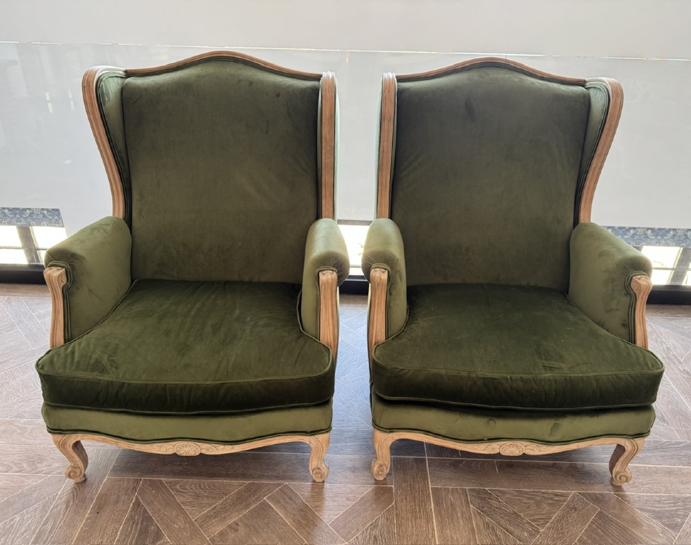 A pair of French wingback armchairs upholstered in olive green velvet with carved timber frames and cabriole legs. View XII