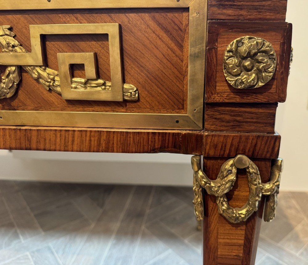 A French Louis XVI style writing desk featuring a green leather insert, wood parquetry veneer, three frieze drawers, and gilt bronze mounts. View VII