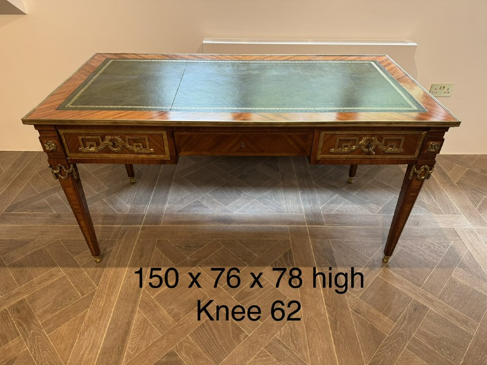 A French Louis XVI style writing desk featuring a green leather insert, wood parquetry veneer, three frieze drawers, and gilt bronze mounts. View XII