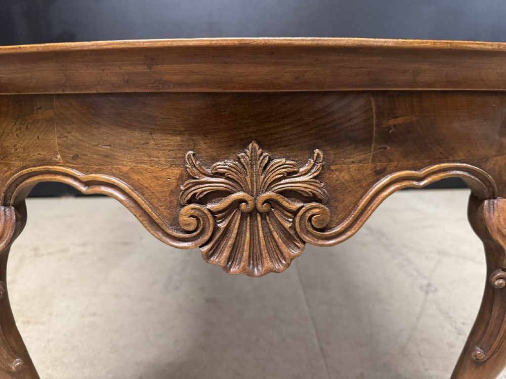 A burr walnut low coffee table featuring cabriole legs, a carved shell motif on the central apron, and a raised moulded edge around the top. View VIII