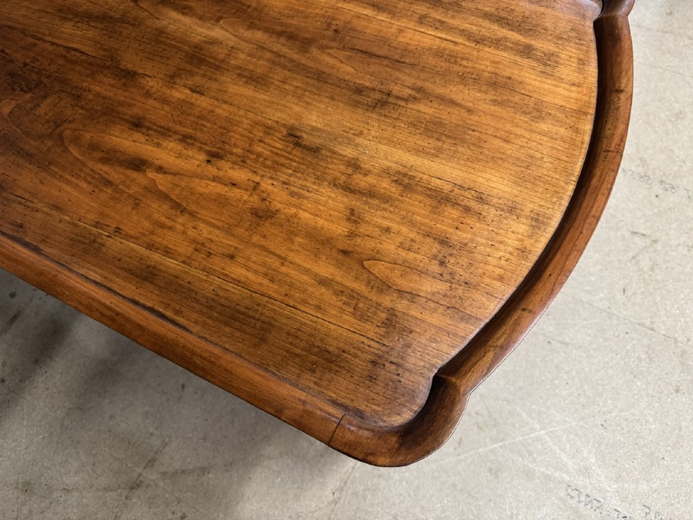 A burr walnut low coffee table featuring cabriole legs, a carved shell motif on the central apron, and a raised moulded edge around the top. View IX