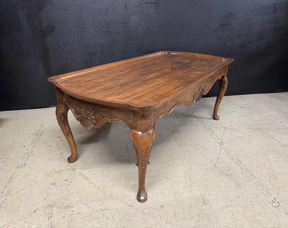 A burr walnut low coffee table featuring cabriole legs, a carved shell motif on the central apron, and a raised moulded edge around the top. View XII