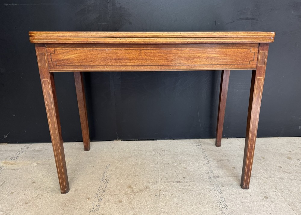 A rectangular Georgian mahogany fold-over tea table featuring fine boxwood string inlay and straight tapered legs. View II