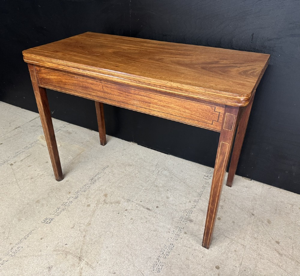 A rectangular Georgian mahogany fold-over tea table featuring fine boxwood string inlay and straight tapered legs. View III