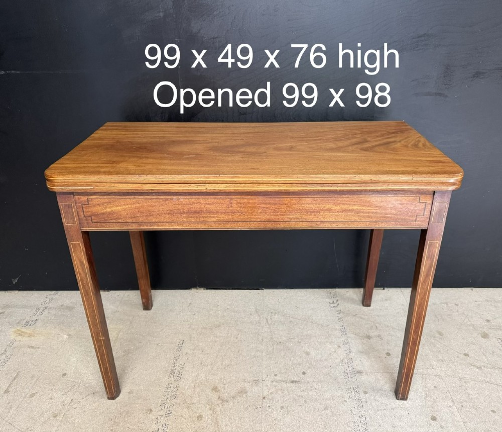 A rectangular Georgian mahogany fold-over tea table featuring fine boxwood string inlay and straight tapered legs. View IV