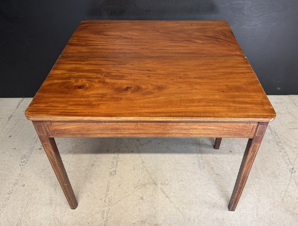 A rectangular Georgian mahogany fold-over tea table featuring fine boxwood string inlay and straight tapered legs. View V