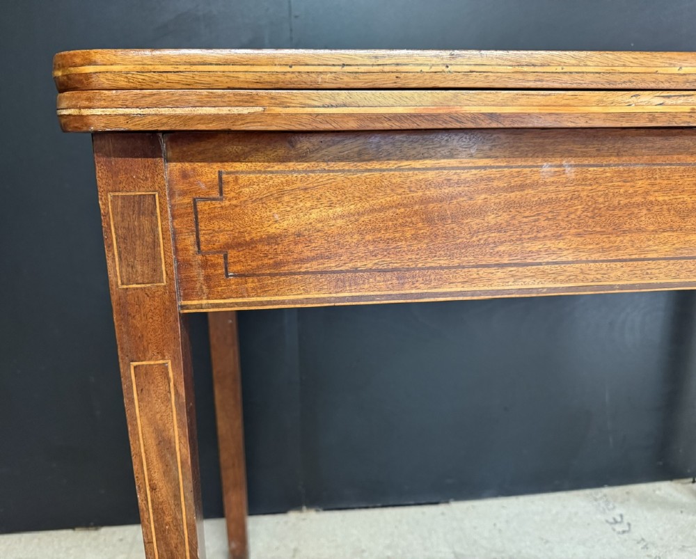 A rectangular Georgian mahogany fold-over tea table featuring fine boxwood string inlay and straight tapered legs. View VIII