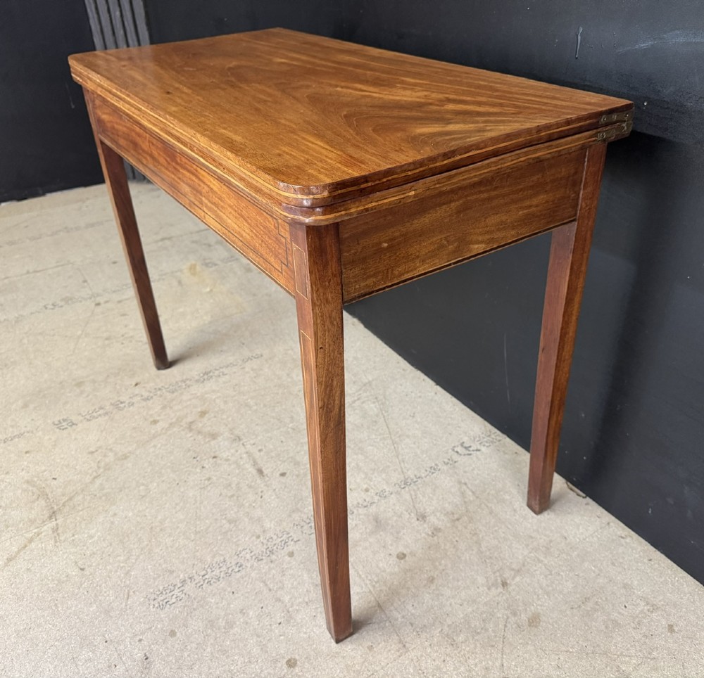 A rectangular Georgian mahogany fold-over tea table featuring fine boxwood string inlay and straight tapered legs. View IX