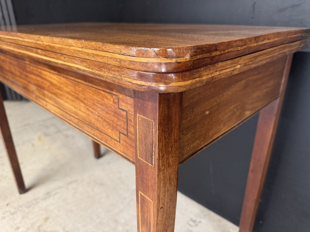 A rectangular Georgian mahogany fold-over tea table featuring fine boxwood string inlay and straight tapered legs. View X