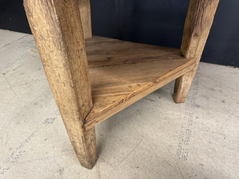 A rustic antique pine cricket table featuring a circular wooden top supported by three sturdy legs and a low triangular shelf. View IV