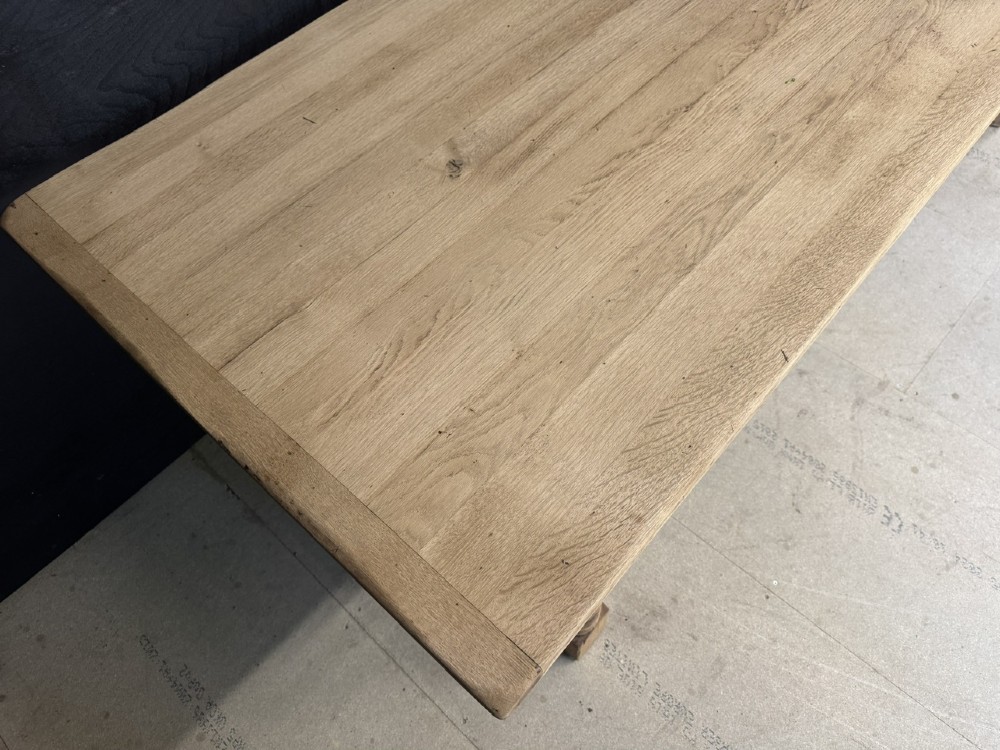 Large rectangular light oak farmhouse dining table featuring turned legs and an H-stretcher base. View VII