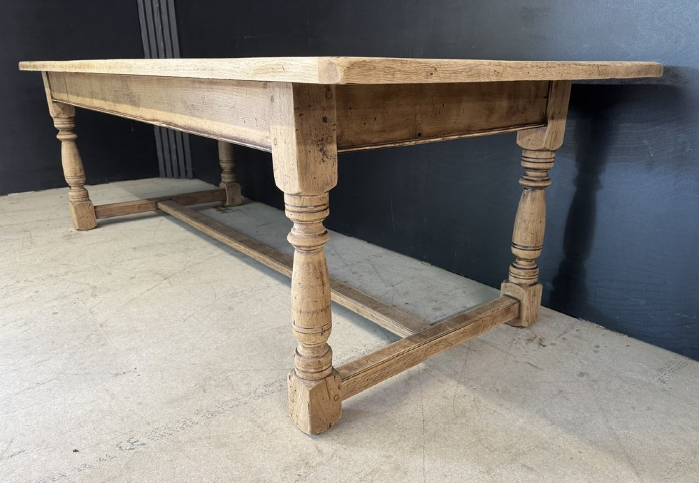 Large rectangular light oak farmhouse dining table featuring turned legs and an H-stretcher base. View VIII