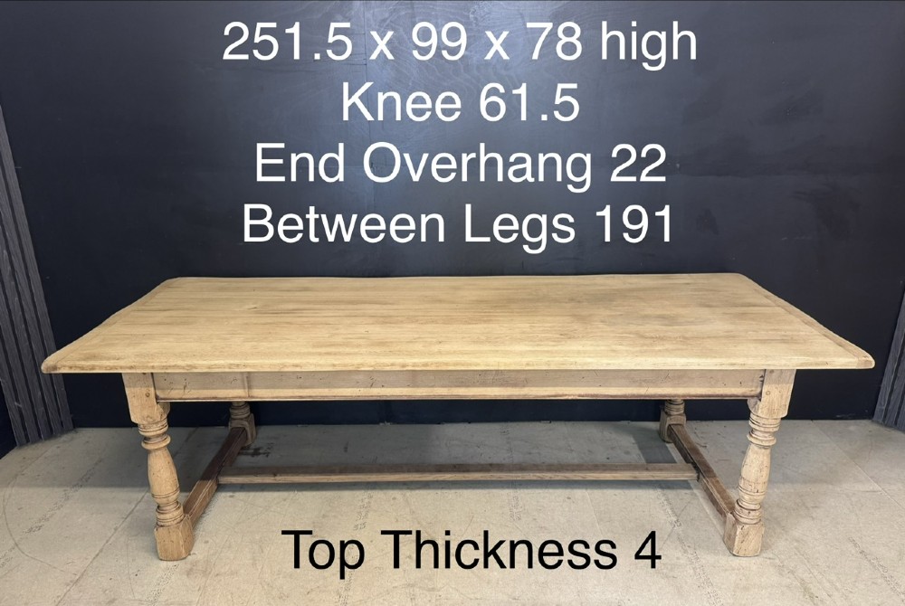 Large rectangular light oak farmhouse dining table featuring turned legs and an H-stretcher base. View XII