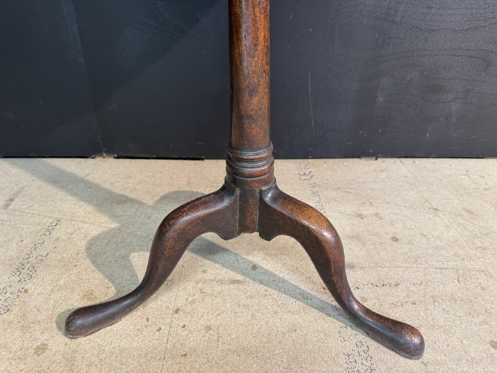 A Georgian solid oak tilt-top table with a circular surface supported by a turned pedestal column and three cabriole tripod legs. View III