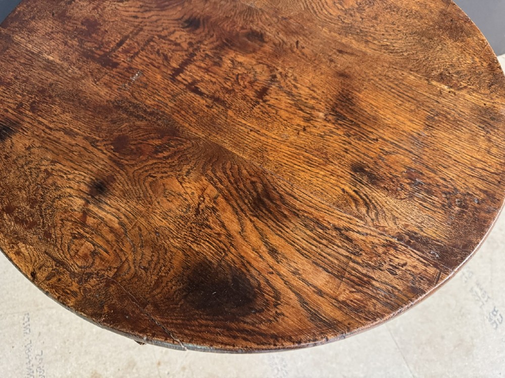 A Georgian solid oak tilt-top table with a circular surface supported by a turned pedestal column and three cabriole tripod legs. View VIII