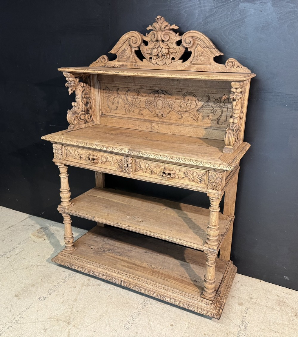 A 19th-century French carved oak buffet featuring an ornate crest, open shelf, turned columns, and carved drawers. View II