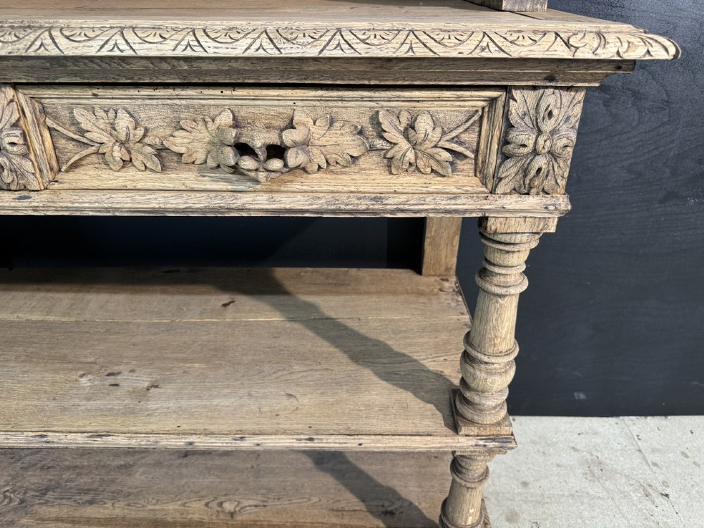 A 19th-century French carved oak buffet featuring an ornate crest, open shelf, turned columns, and carved drawers. View VI