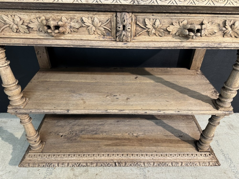 A 19th-century French carved oak buffet featuring an ornate crest, open shelf, turned columns, and carved drawers. View VIII