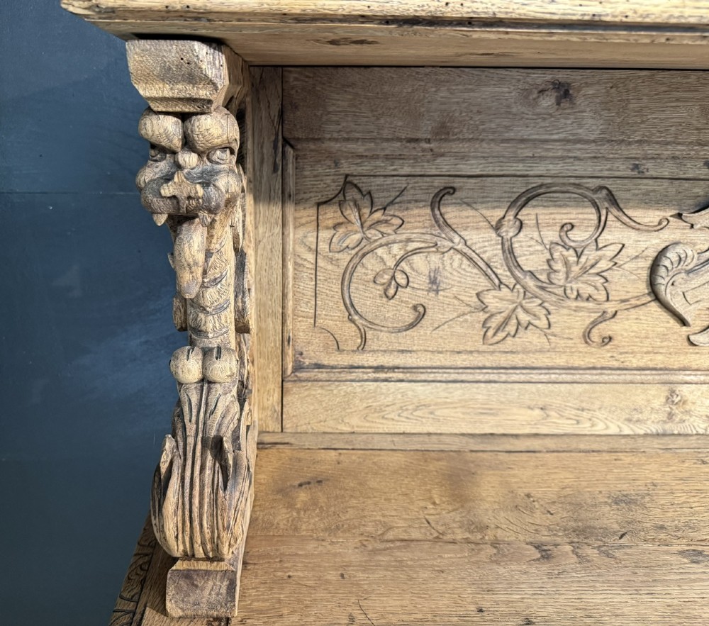 A 19th-century French carved oak buffet featuring an ornate crest, open shelf, turned columns, and carved drawers. View X