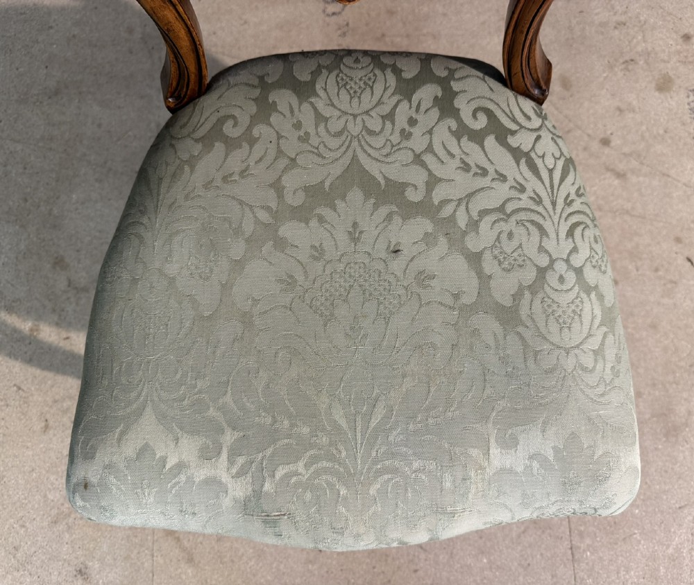 A Victorian balloon back side chair featuring a carved warm brown wood frame, cabriole front legs, and a sage green damask upholstered seat. View VII