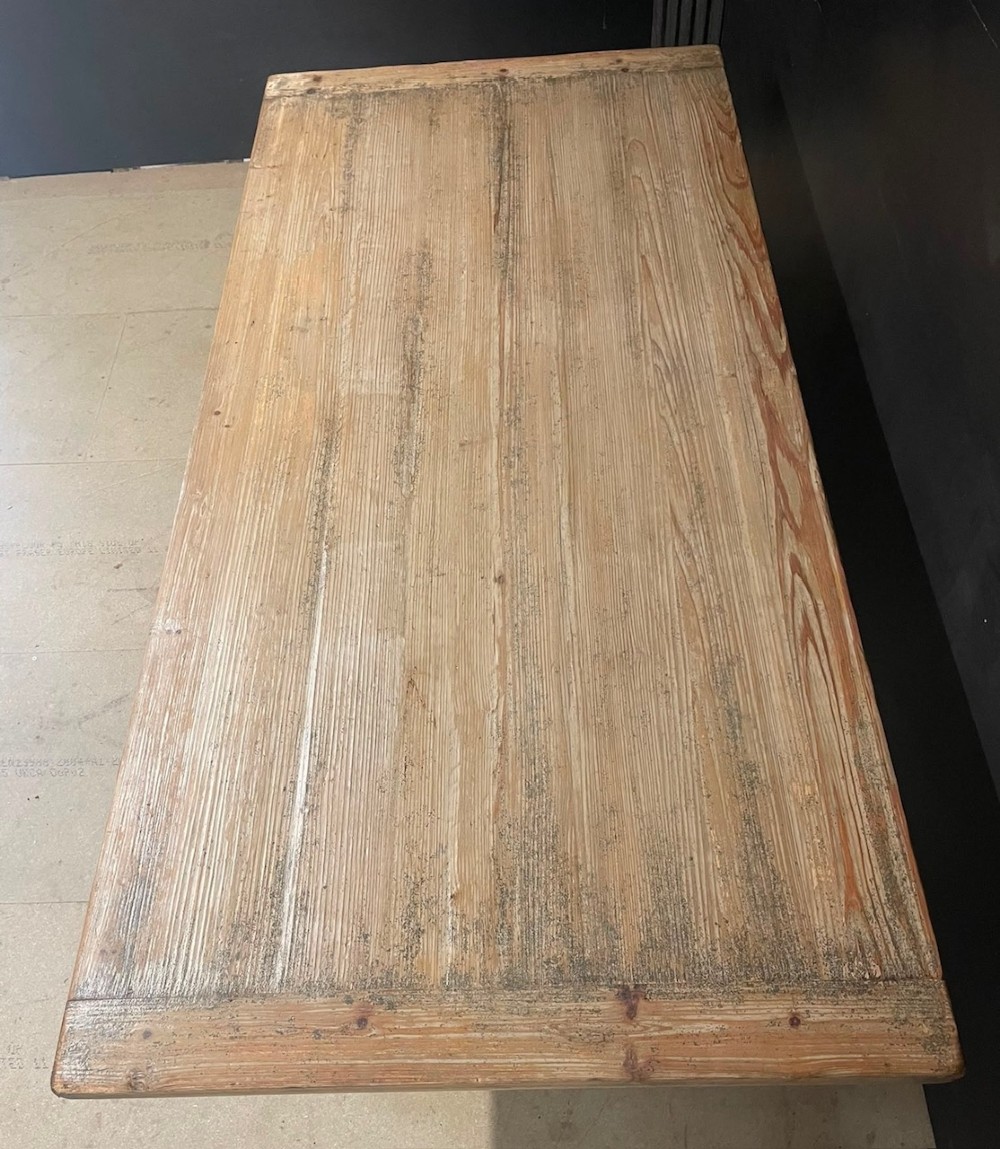 A large, pale pine farmhouse dining table featuring a solid timber top and a sturdy trestle-style base with diagonal bracing. View VIII