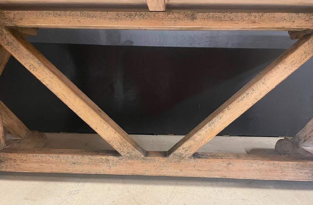 A large, pale pine farmhouse dining table featuring a solid timber top and a sturdy trestle-style base with diagonal bracing. View XI