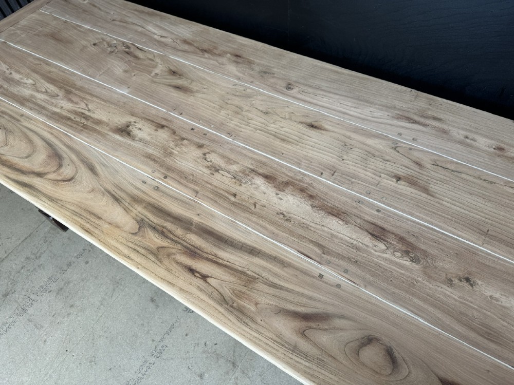 A rustic wooden dining table with a natural scrubbed timber top, carved apron frieze, turned legs, and a floor-level H-stretcher. View XIV