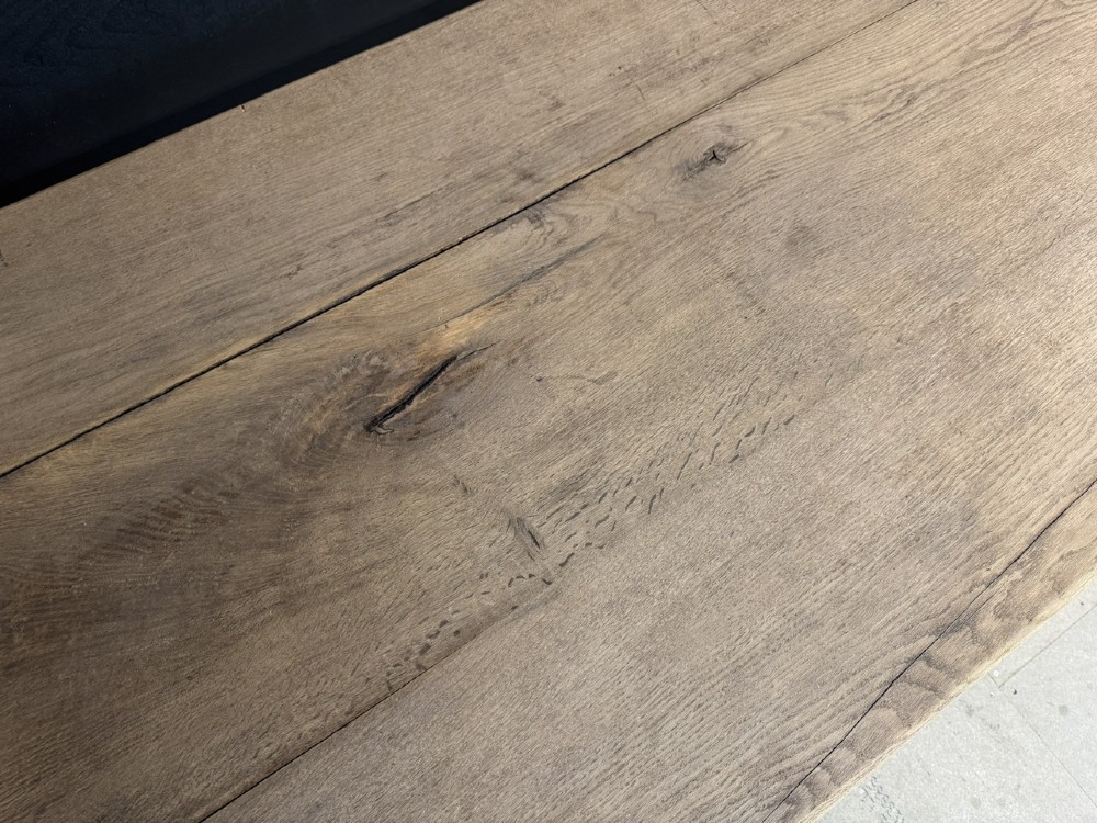 A rectangular bleached oak farmhouse dining table with turned legs, breadboard ends, and a low central stretcher base. View XIII