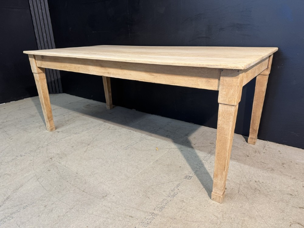 A rectangular light oak dining table featuring clean straight edges, a planked top, and simple tapered legs against a neutral background. View III